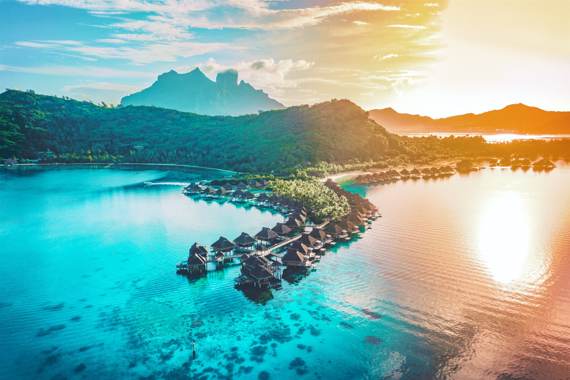 Overwater bungalows over a Tahitian lagoon, French Polynesia